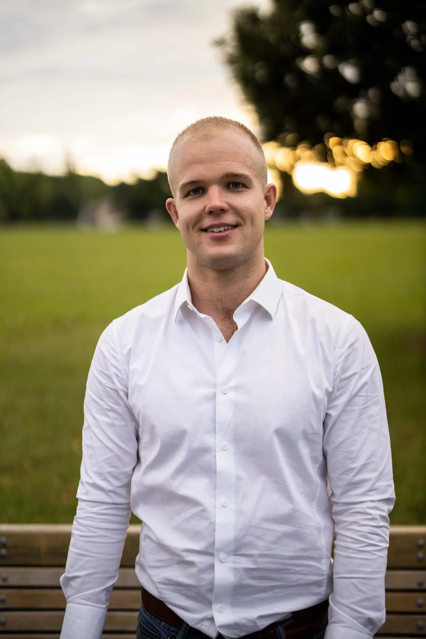 Sam Wilkinson standing in a park at sunset